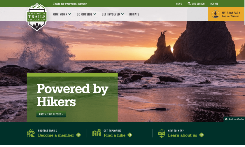 The WTA home page features a bold, dark green bar above and below a featured image with the tagline "Powered by Hikers". The dark greens have high contrast with the white and light-green text laid on top of them.